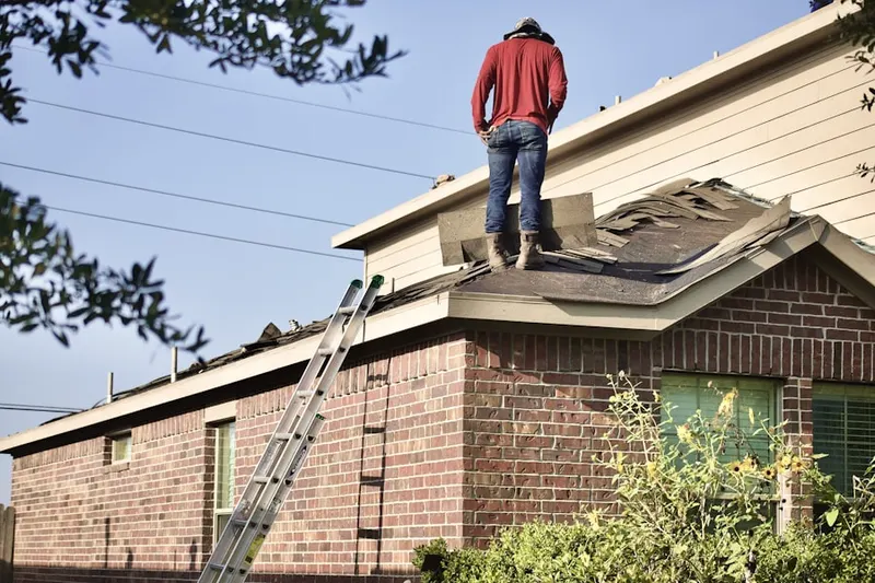 Professional roofer working on a residential roof in Ehrenfeld